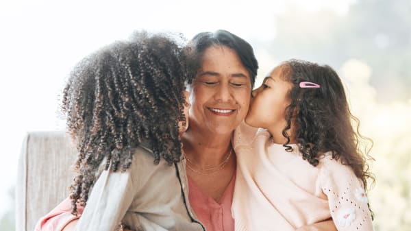 A family sits hugging eachother and smiling